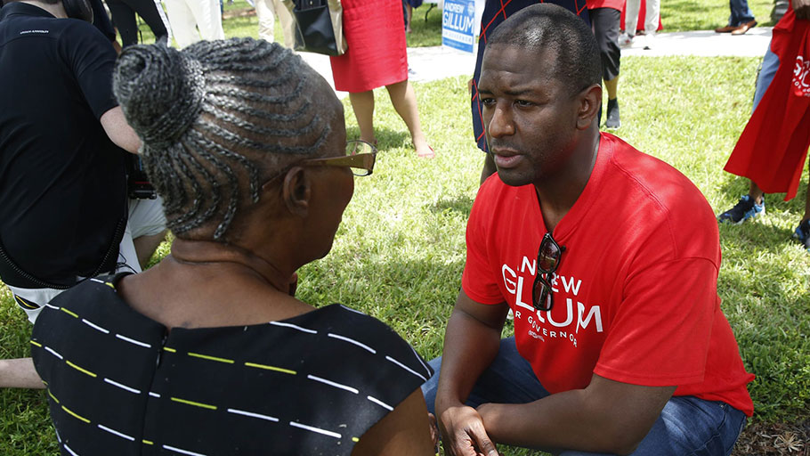 Democratic gubernatorial candidate Andrew Gillum talks with a supporter after speaking to voters and public school teachers at a rally in Miami Gardens, Florida.