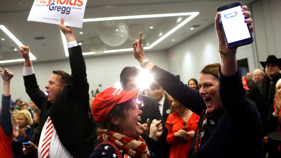 Republican supporters cheer after Iowa’s Republican candidate for governor won re-election. Photograph: Joshua Lott/Getty Images