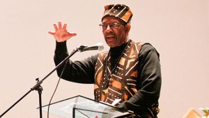 Ron Daniels, who held the first Kwanzaa celebration in Youngstown 50 years ago, speaks during a Kwanzaa celebration at New Bethel Baptist Church on Wednesday night.