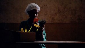 A worker scans the QR code on a bundle of vanilla pods in Madagascar.