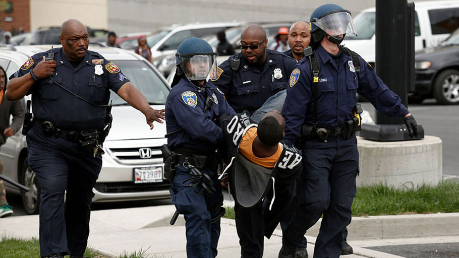 BALTIMORE, MD - APRIL 27: Baltimore Police officers arrest a man near Mowdamin Mall, April 27, 2015 in Baltimore, Maryland. The funeral service for Freddie Gray, who died last week while in Baltimore Police custody, was held on Monday morning.