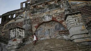 A woman climbs the stairs on the remains of Sans-Souci Palace in 2017.