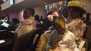 A child flips the pages of the Bible during Easter Sunday service at Wheat Street Baptist Church. Many of the church's members grew up going here their entire lives.