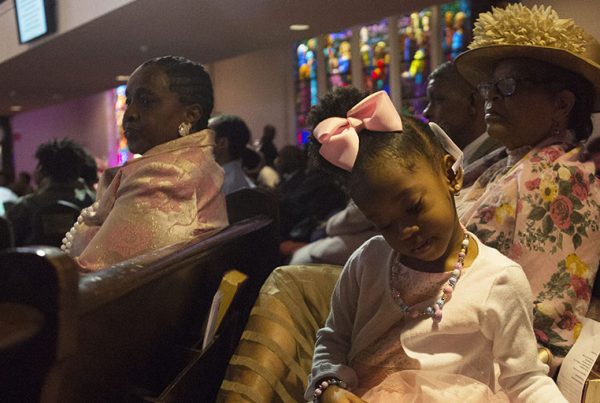 A child flips the pages of the Bible during Easter Sunday service at Wheat Street Baptist Church. Many of the church's members grew up going here their entire lives.
