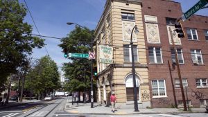 A man walks past the Prince Hall Masonic Lodge. John Wesley Dobbs, dubbed the unofficial mayor of Sweet Auburn, erected this building in 1937 while he was Grand Master. Dobbs used this building in his work to galvanize African-American political power in Atlanta. Martin Luther King Jr. eventually used an office in this building to start the Southern Christian Leadership Conference. Image by Evey Wilson