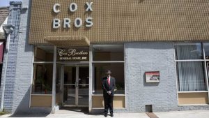 Melvin J. Fulton stands outside Cox Brothers Funeral Home. Fulton has worked here since 1980. Image by Evey Wilson