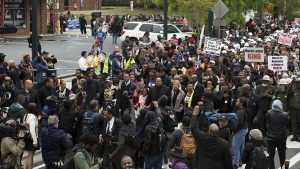 Hundreds participate in the commemorative march retracing part of Martin Luther King Jr.’s funeral procession that happened 50 years prior. Fifty years earlier, thousands of people walked behind Martin Luther King Jr.’s casket as it was drawn by mules from Ebenezer Baptist Church to Morehouse. Image by Evey Wilson