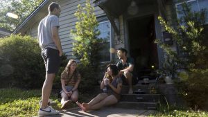 Tyler Conn, Jessica Vass, Makaela Davis and David Miller sit outside in front of Davis' home in the Sweet Auburn District of the Old Fourth Ward. Image by Evey Wilson