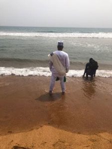 Jay Speights stands in the surf of the Bight of Benin, where slave ships departed into the Atlantic Ocean toward the Americas. (Family photo)