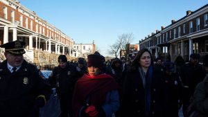 Mayor Catherine Pugh tours a neighborhood with city and law-enforcement officials in February.