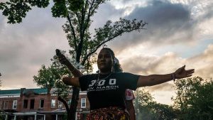 Erricka Bridgeford, the organizer of Baltimore Ceasefire, doing a spiritual cleanse at the site of a recent murder.