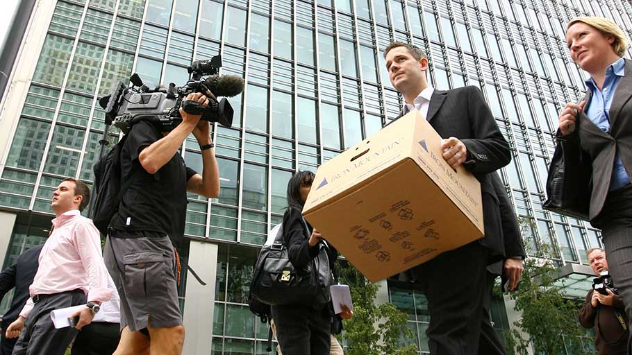 A UK employee of Lehman Brothers carrying a box after clearing his desk when the US investment firm declared bankruptcy, London, September 15, 2008