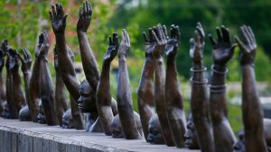 The bronze statue called "Raise Up" at the National Memorial for Peace and Justice, a memorial to honor thousands of people killed in lynchings, on April 23, 2018, in Montgomery, Ala.