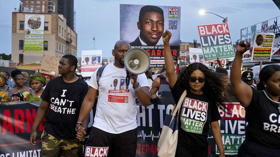 Activists with Black Lives Matter protest in the Harlem neighborhood of New York, Tuesday, July 16, 2019, in the wake of a decision by federal prosecutors who declined to bring civil rights charges against New York City police Officer Daniel Pantaleo, in the 2014 chokehold death of Eric Garner.
