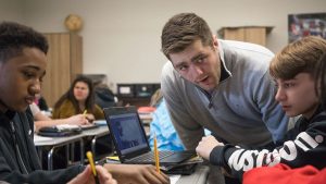 At Fort Dodge Middle School in Fort Dodge, Iowa, Tom McClimon in March listens to eighth-graders Kyron Wilson, left, and Kade Nielsen as they discuss the lasting effects of slavery.