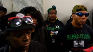 Activists line up June 19, 2019, for a House Judiciary Committee panel hearing on reparations for the descendants of slaves.