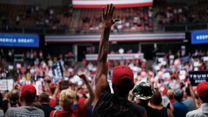 People react as President Trump speaks to supporters at a rally on August 15, 2019, in Manchester, New Hampshire.