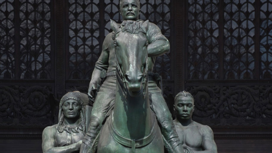 The statue depicts Roosevelt on horseback, with a Native American man and an African man