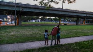 Octavia Scudder, center, watches Aaliyah, left, and A'mora as they walk near I-81.