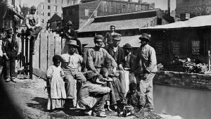 Former enslaved people in a Southern town shortly after the end of the Civil War, circa 1865.