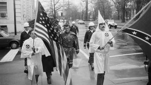 KKK leader Virgil Griffin marches with other Klansmen around the North Carolina State Capitol in 1982 , to protest the imprisonment of a white man who bombed a black-owned newspaper in 1973.