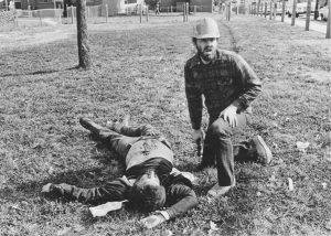 A WVO member kneels beside a victim of the shooting.