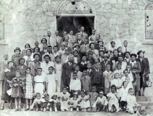 Antioch East Baptist Church members stand on the steps of their hand built sanctuary, the Old Stone Church, in Candler Park in 1948.