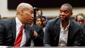 Sen. Cory Booker, D-N.J., left, talks with author Ta-Nehisi Coates,