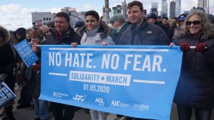 Protesters hold a banner during a Jewish solidarity march across the Brooklyn Bridge in New York City on January 5, 2020.