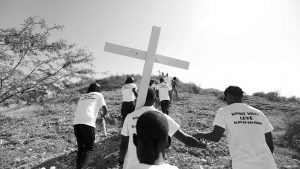 Mourners carry a cross in Port-au-Prince, in January, 2019, to honor the victims of the 7.0-magnitude earthquake that devastated Haiti