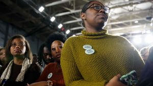 Attendees wear buttons supporting Sen. Elizabeth Warren at a campaign event at Clark Atlanta University on November 21, 2019, in Atlanta, Georgia.