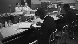 African-American students from Saint Augustine College study while participating in a sit-in at a lunch counter reserved for white customers in Raleigh, N.C.