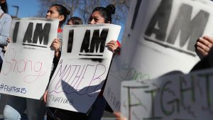 Fast food workers and union members carry signs as they stage a protest outside of a McDonald's restaurant in Oakland, Calif., on Feb. 12, 2018, the 50th anniversary of the historic Memphis Sanitation Strike that was led by Dr. Martin Luther King Jr.