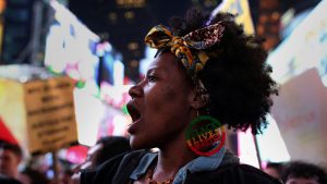 A protester wearing a "Black Lives Matter" earring chants slogans as she marches in Times Square in the Manhattan borough of New York City, during a protest against the death of Stephon Clark in Sacramento, California, U.S. March 28, 2018.