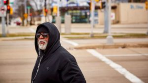 Fred Royal, the Milwaukee head of the NAACP, walks empty streets near his home in a largely black neighborhood hit hard by the coronavirus. He knows three people who have died.