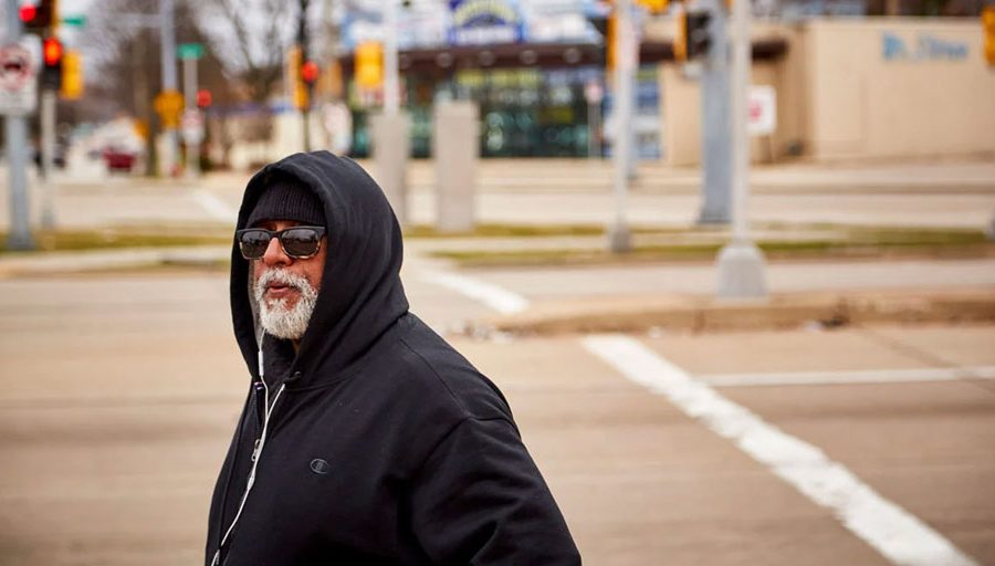 Fred Royal, the Milwaukee head of the NAACP, walks empty streets near his home in a largely black neighborhood hit hard by the coronavirus. He knows three people who have died.