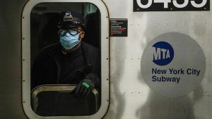 A New York MTA worker wears personal protective equipment at the Grand Army Plaza subway station in Brooklyn.