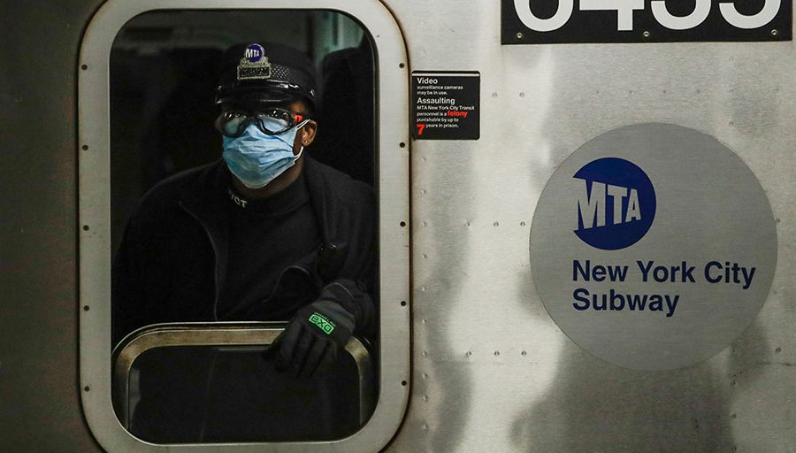A New York MTA worker wears personal protective equipment at the Grand Army Plaza subway station in Brooklyn.