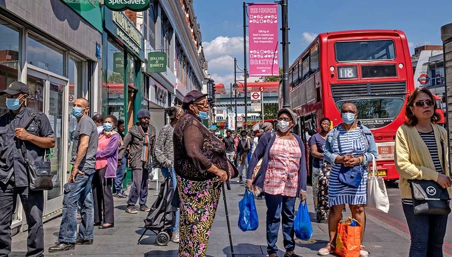 Shoppers on Brixton High Street in South London. As in the United States, ethnic minorities are disproportionately falling victim to the pandemic.