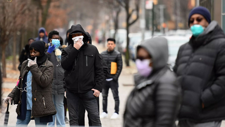 People who believe they have COVID-19, and who meet the criteria, wait in line to be pre-screened for the coronavirus outside of the Brooklyn Hospital Center on March 20 in Brooklyn, New York