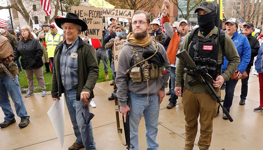 Armed protesters provide security as demonstrators take part in an "American Patriot Rally," on the steps of the Michigan State Capitol in Lansing, on April 30, 2020