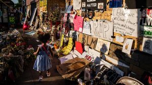 Somia Stewart, 3, walks through a memorial for Floyd at the intersection of 38th Street and Chicago Avenue in Minneapolis earlier this month.