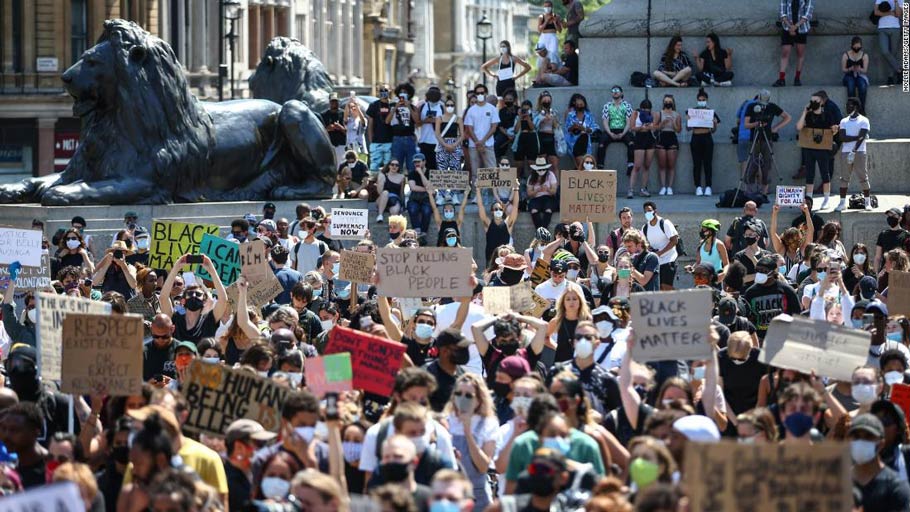 People hold placards as they join a Black Lives Matter march at Trafalgar Square in London on Sunday, May 31.