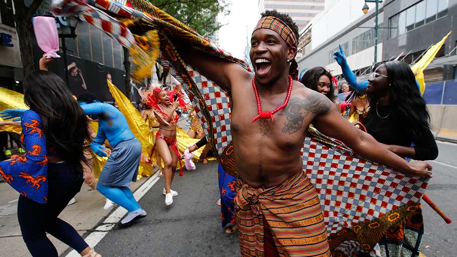 Chi Oriji leads a group in dance during the Juneteenth MusicFest and Parade, recognizing the end of slavery in America in Philadelphia on June 23, 2018.