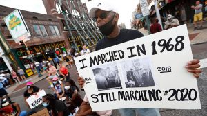 Joe Calhoun holds a sign as demonstrators march in Memphis, Tenn., on Sunday, June 7, 2020, as part of the 12th day of protests following the death of George Floyd, an unarmed black man killed by Police in Minneapolis on Memorial Day.