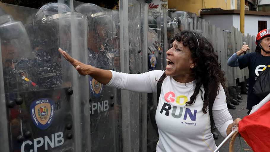 An anti-government demonstrator shouts at police officers during a protest on March 10, 2020 in Caracas. E