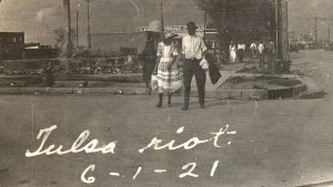 An African American couple walking across a street in Tulsa, Oklahoma, June 1921.