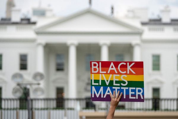 A protester holds a Black Lives Matter sign in front of the White House.