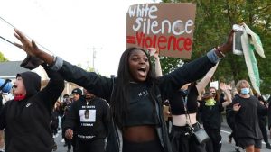 Deante Campbell of Sanford joins student protesters during a demonstration June 4 against institutional racism at South Portland Police Station.