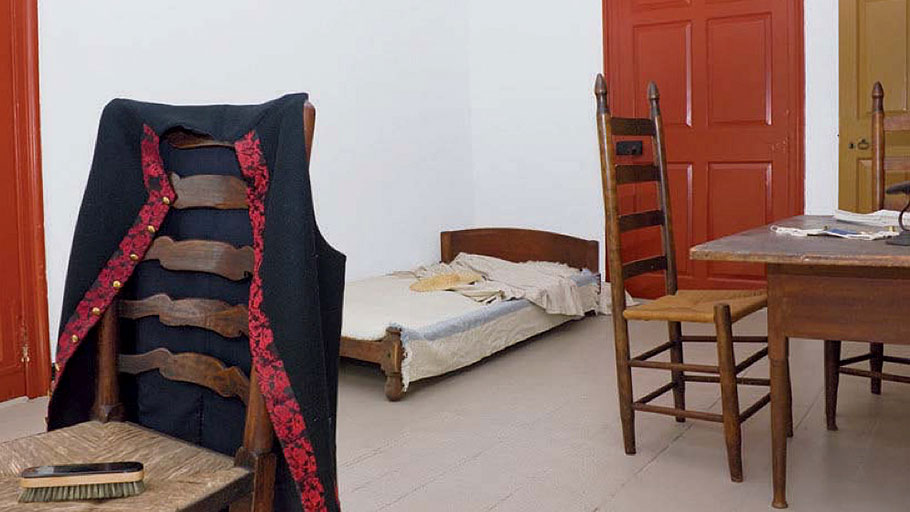 Enslaved people often slept where they worked. A main house chamber held simple bedding.
